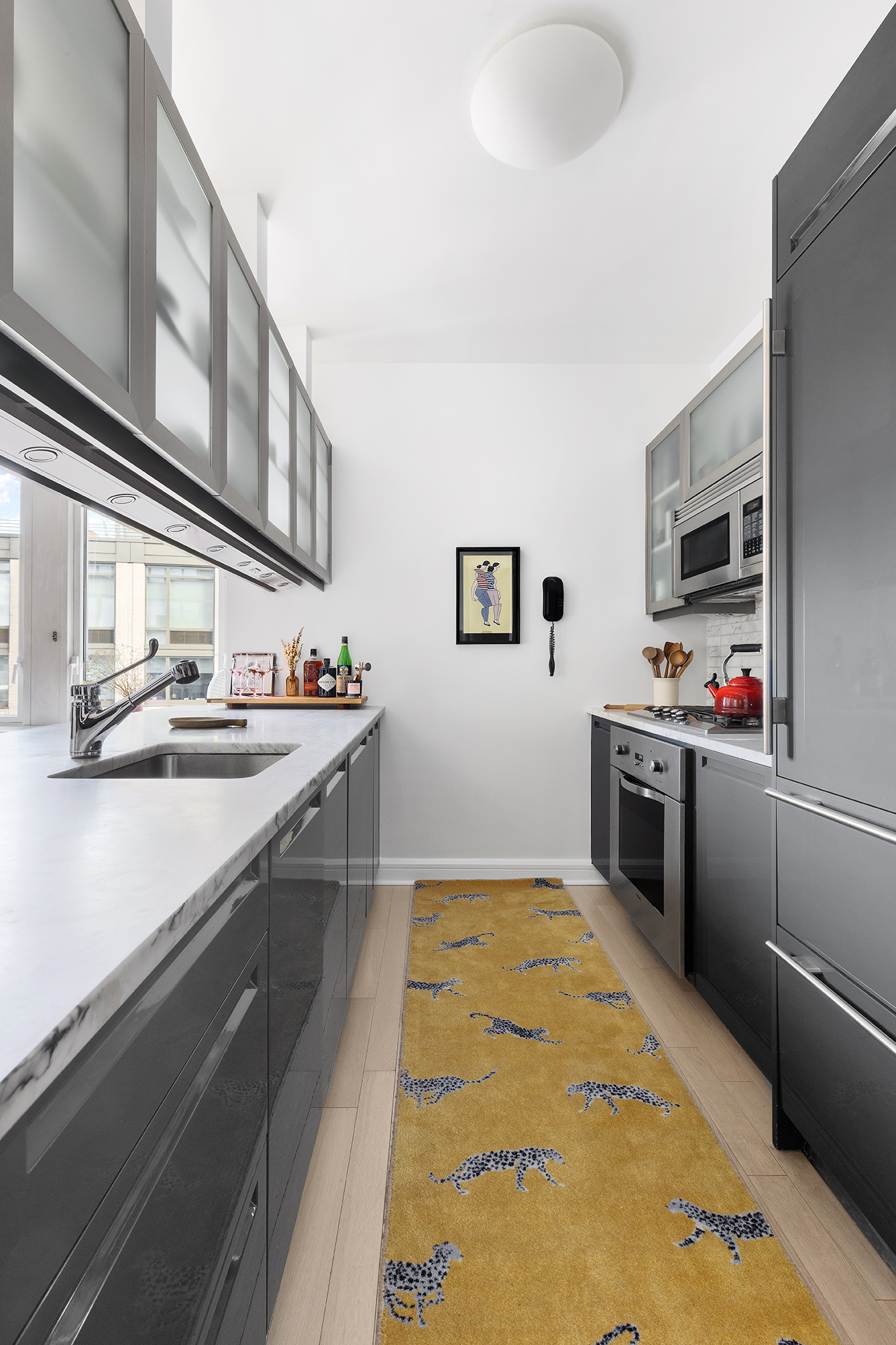 80 Riverside Boulevard, Unit 12D Manhattan, NY 10069 - Photo 6 of 16 a kitchen with stainless steel appliances a sink and a stove