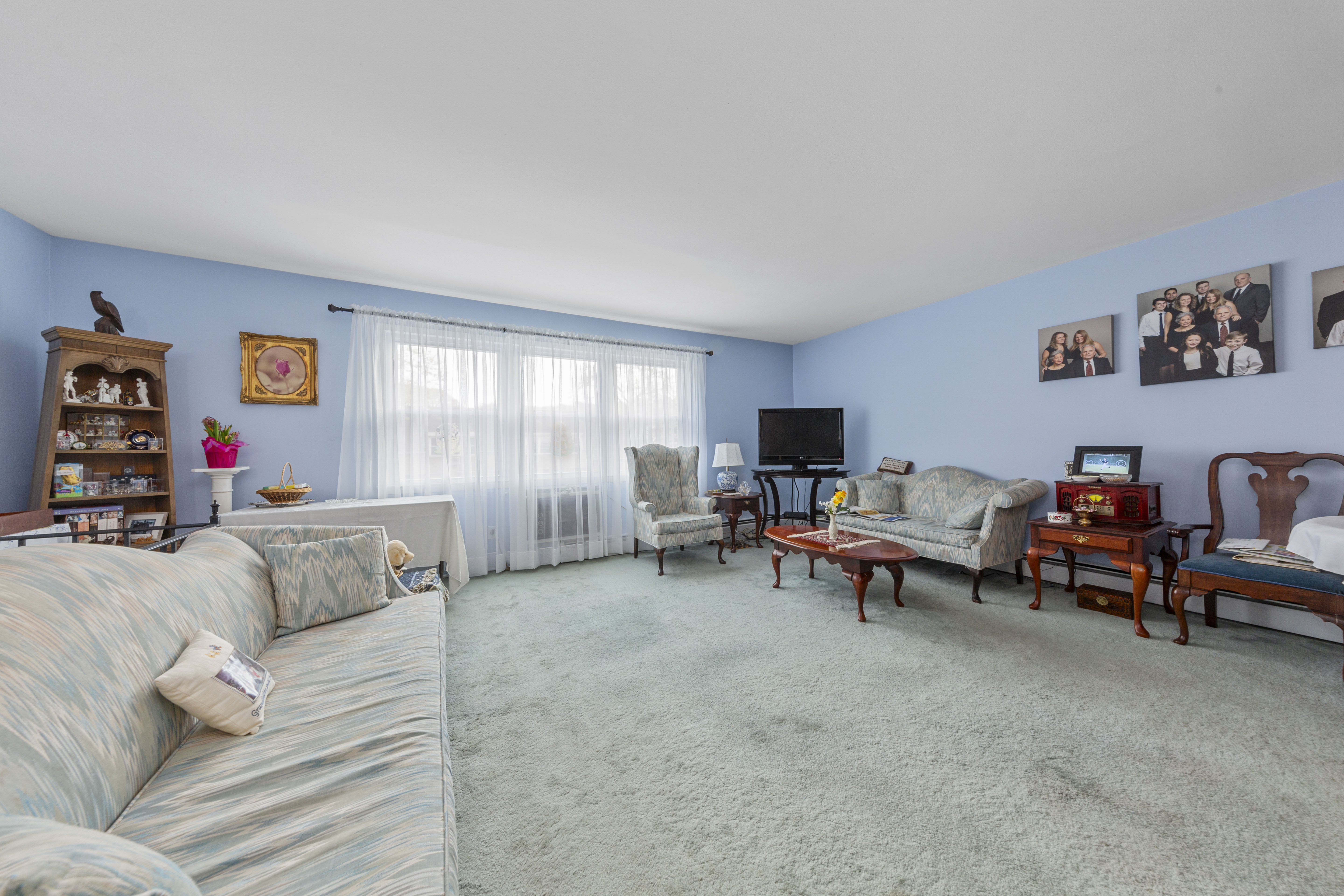 240-47 68th Avenue Queens, NY 11362 - Photo 3 of 39 a living room with furniture and a flat screen tv