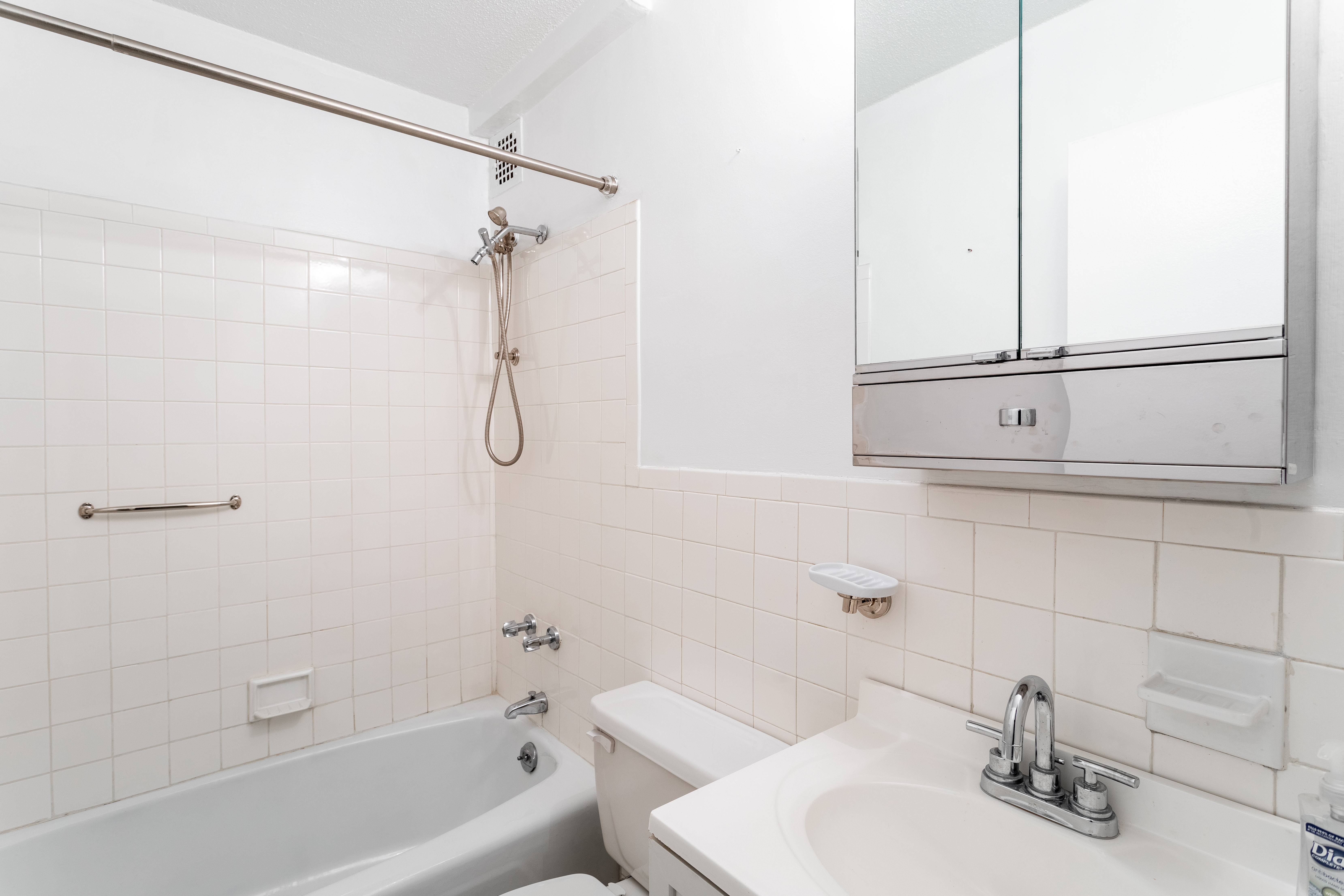 520 East 81st Street, Unit 1F Manhattan, NY 10028 - Photo 7 of 8 a bathroom with a sink a toilet and shower