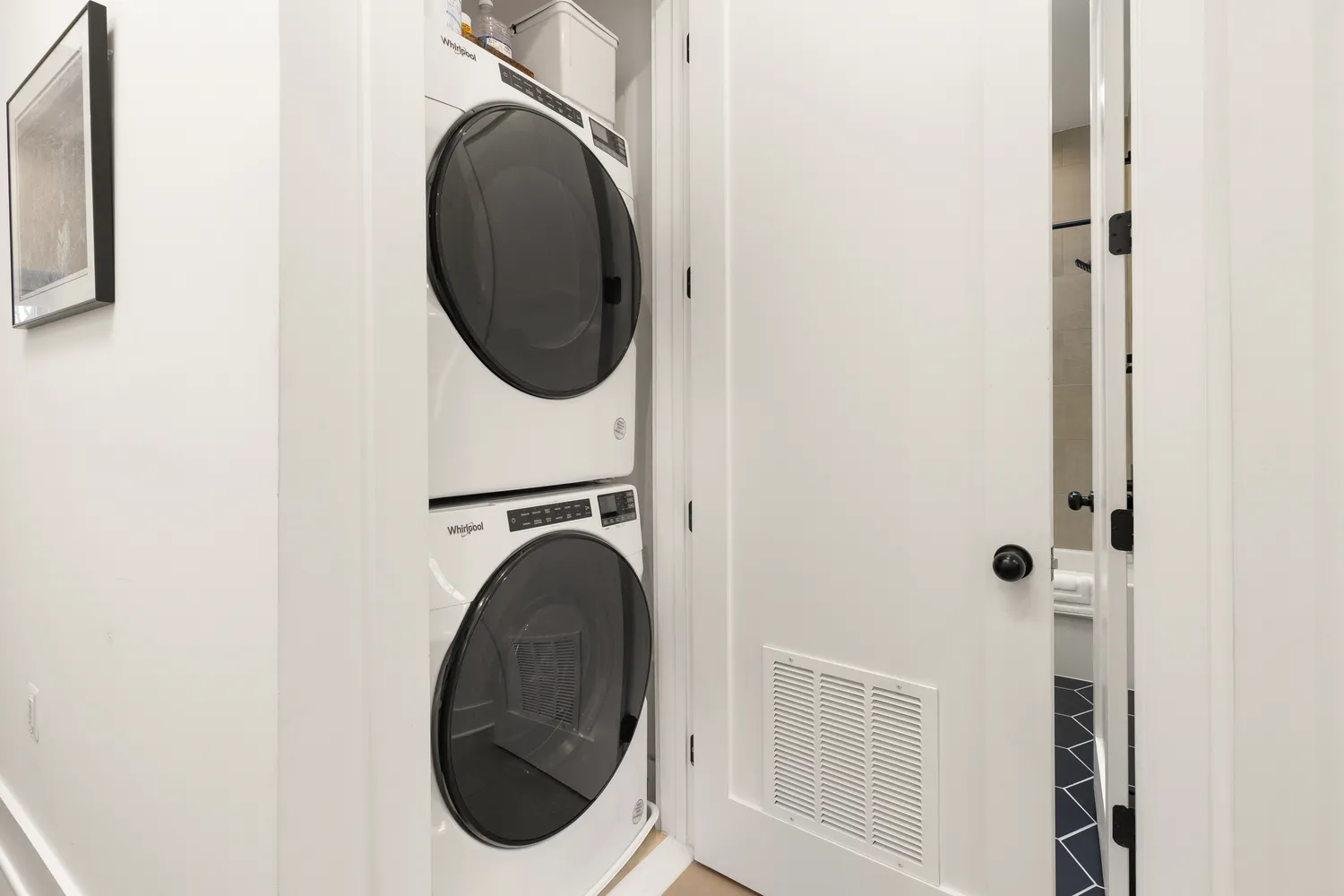 a close view of a utility room with dryer and washer