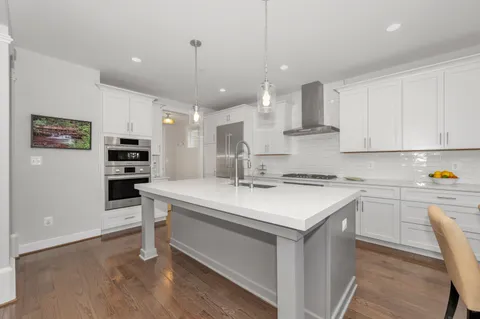 a view of entryway with wooden floor and a front door