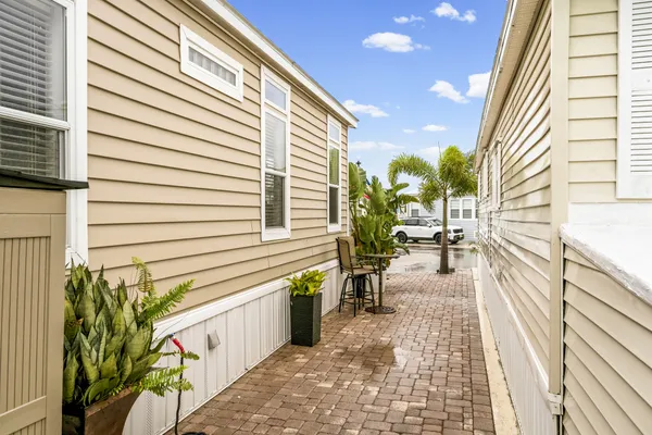 a view of a patio with a table and chairs and wooden floor