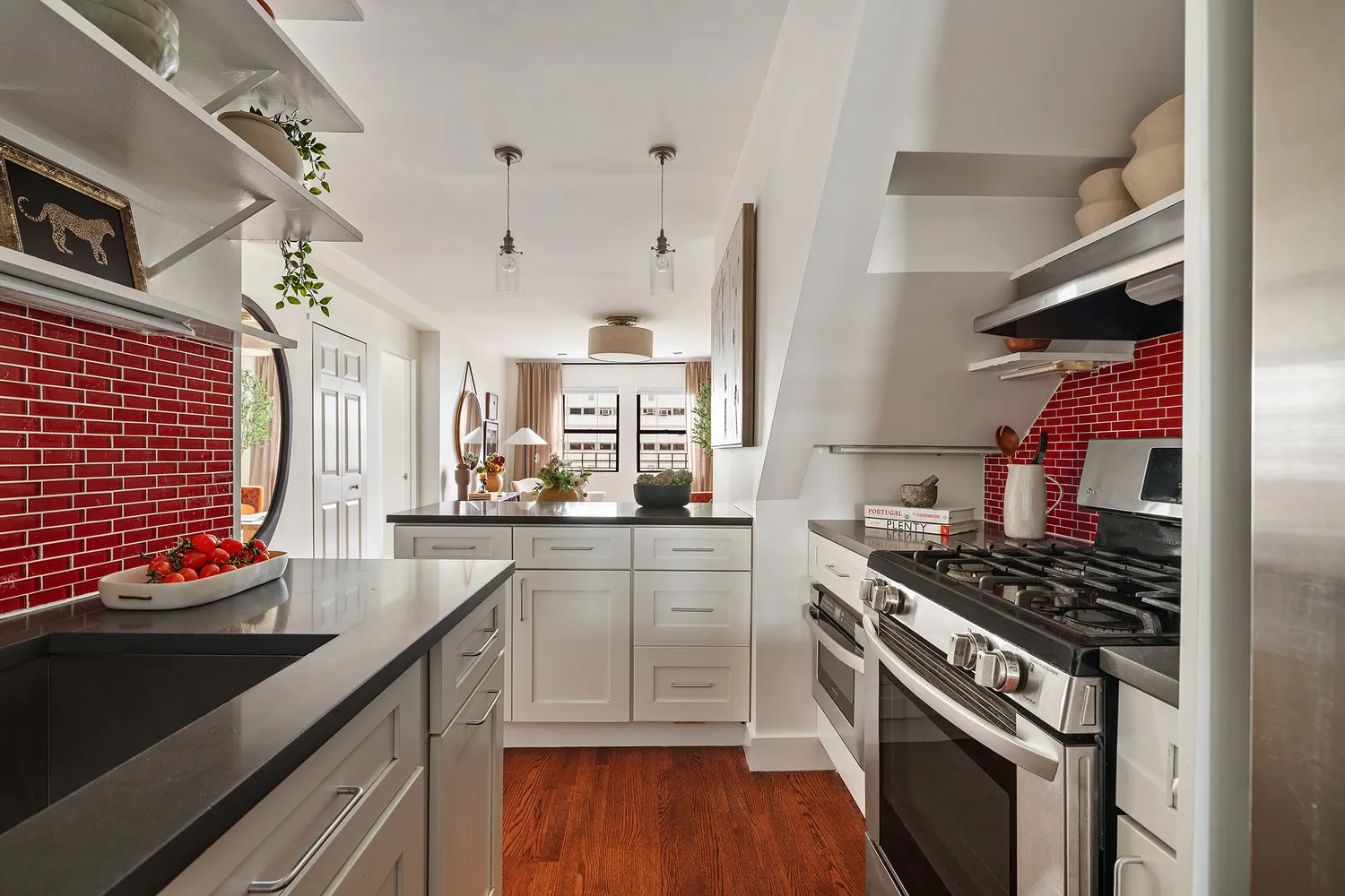 a kitchen with stainless steel appliances a sink stove and cabinets