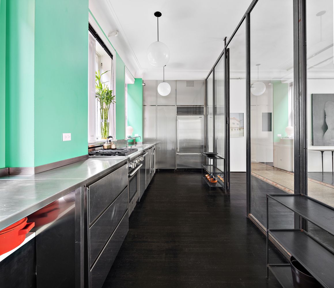 366 Broadway, Unit 5C Manhattan, NY 10013 - Photo 7 of 18 a view of a kitchen with kitchen island a large window