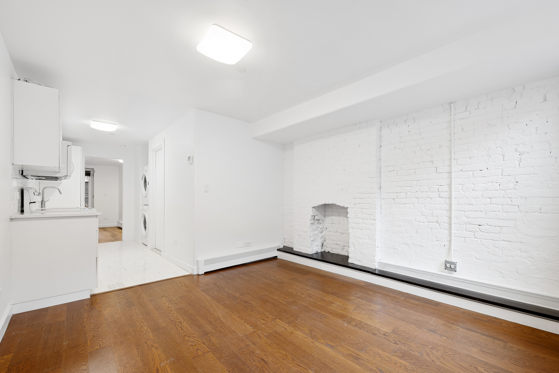 63 Putnam Avenue Brooklyn, NY 11238 - Photo 9 of 11 a view of empty room with wooden floor and fan