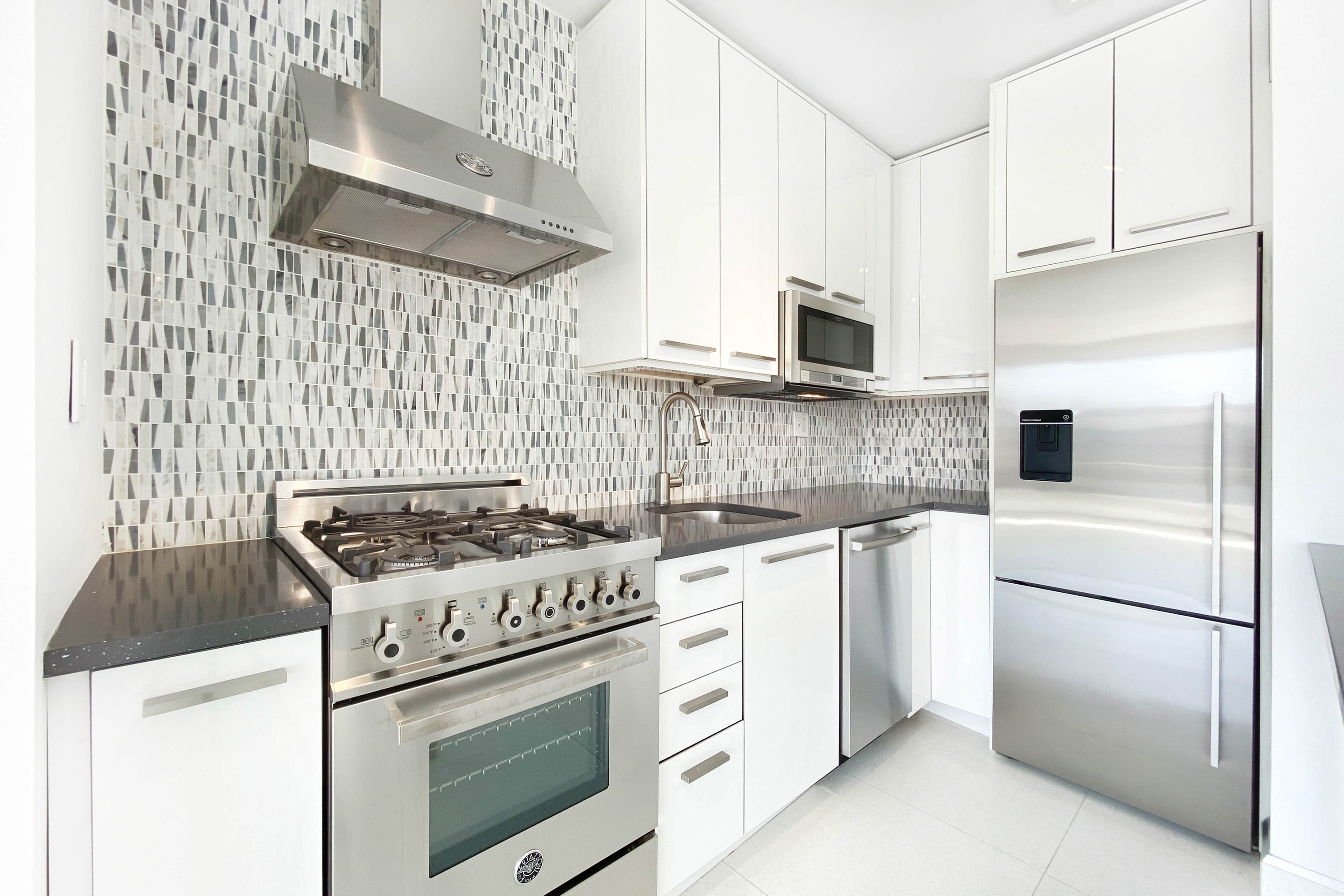 333 East 30th Street, Unit 12H Manhattan, NY 10016 - Photo 5 of 15 a stove top oven sitting inside of a kitchen