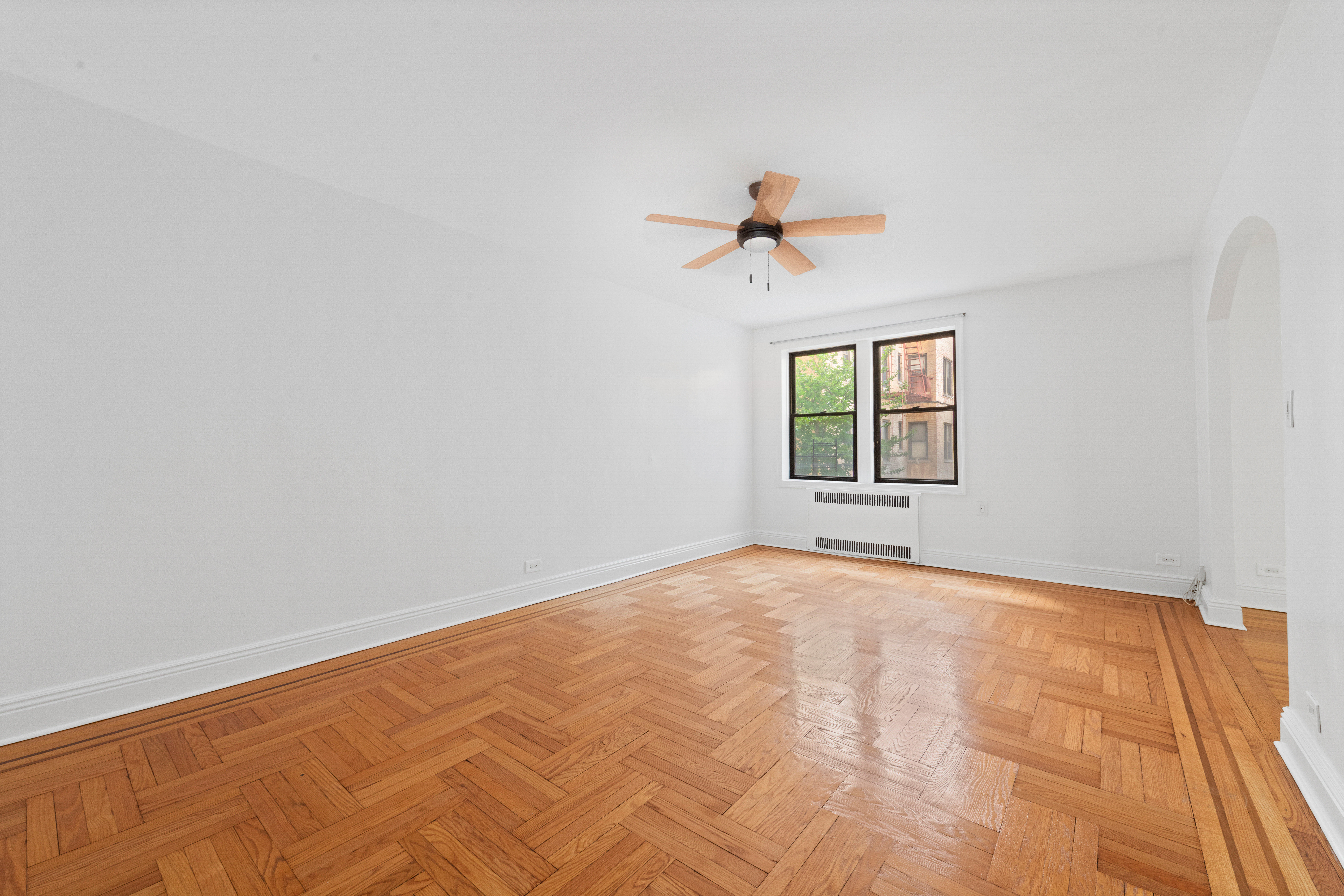 40 Clarkson Avenue Brooklyn, NY 11226 - Photo 15 of 18 a view of a bedroom with a window and a ceiling fan