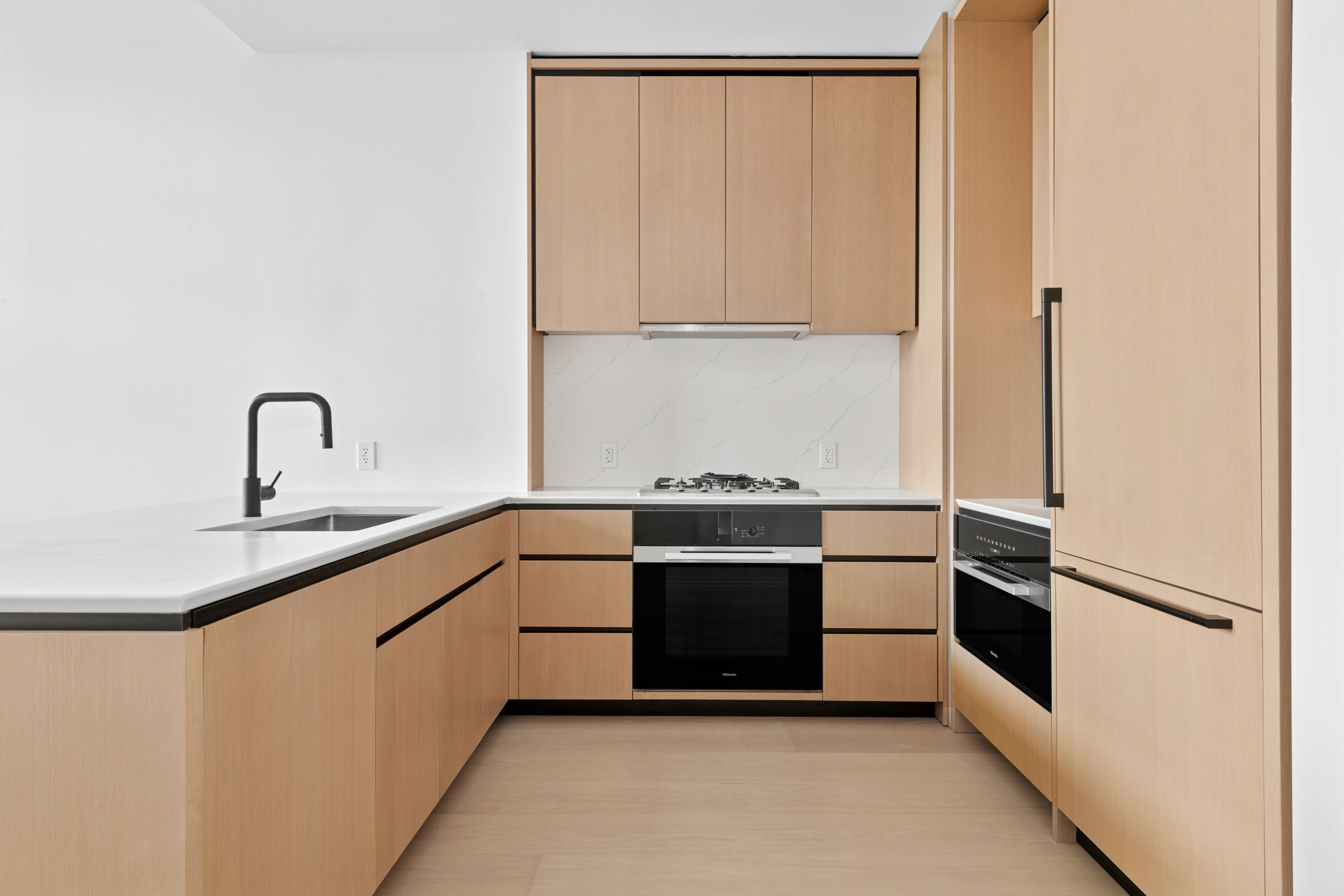 480 Kent Avenue, Unit 21C Brooklyn, NY 11249 - Photo 6 of 23 a kitchen with stainless steel appliances a stove and a refrigerator