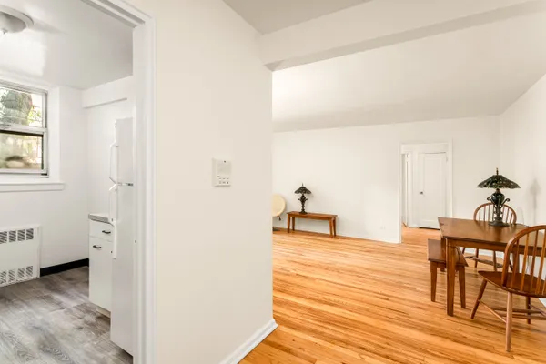 a view of a kitchen and an empty room