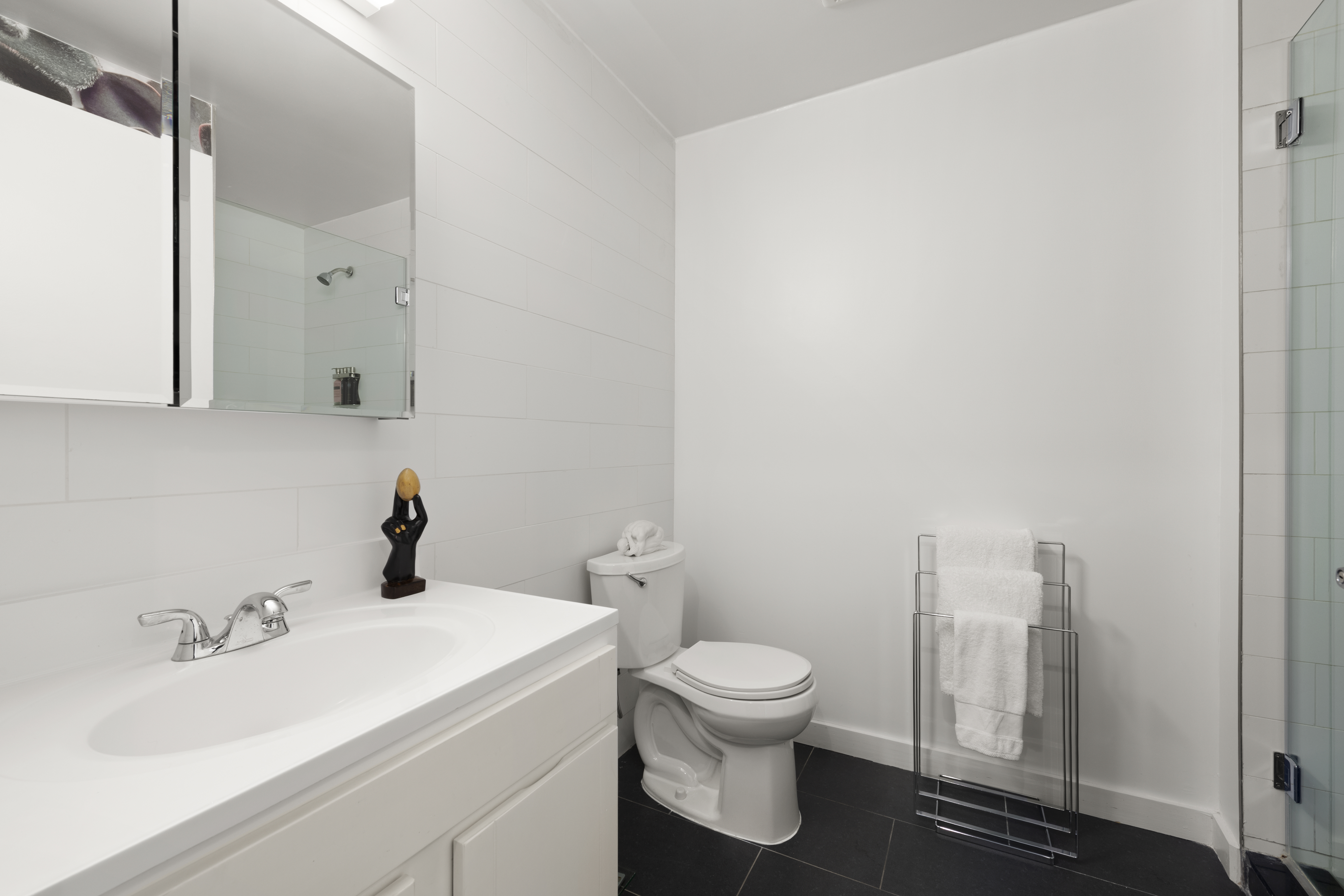 362 West 127th Street, Unit PHA Manhattan, NY 10027 - Photo 6 of 7 a white toilet sitting next to a bathroom sink