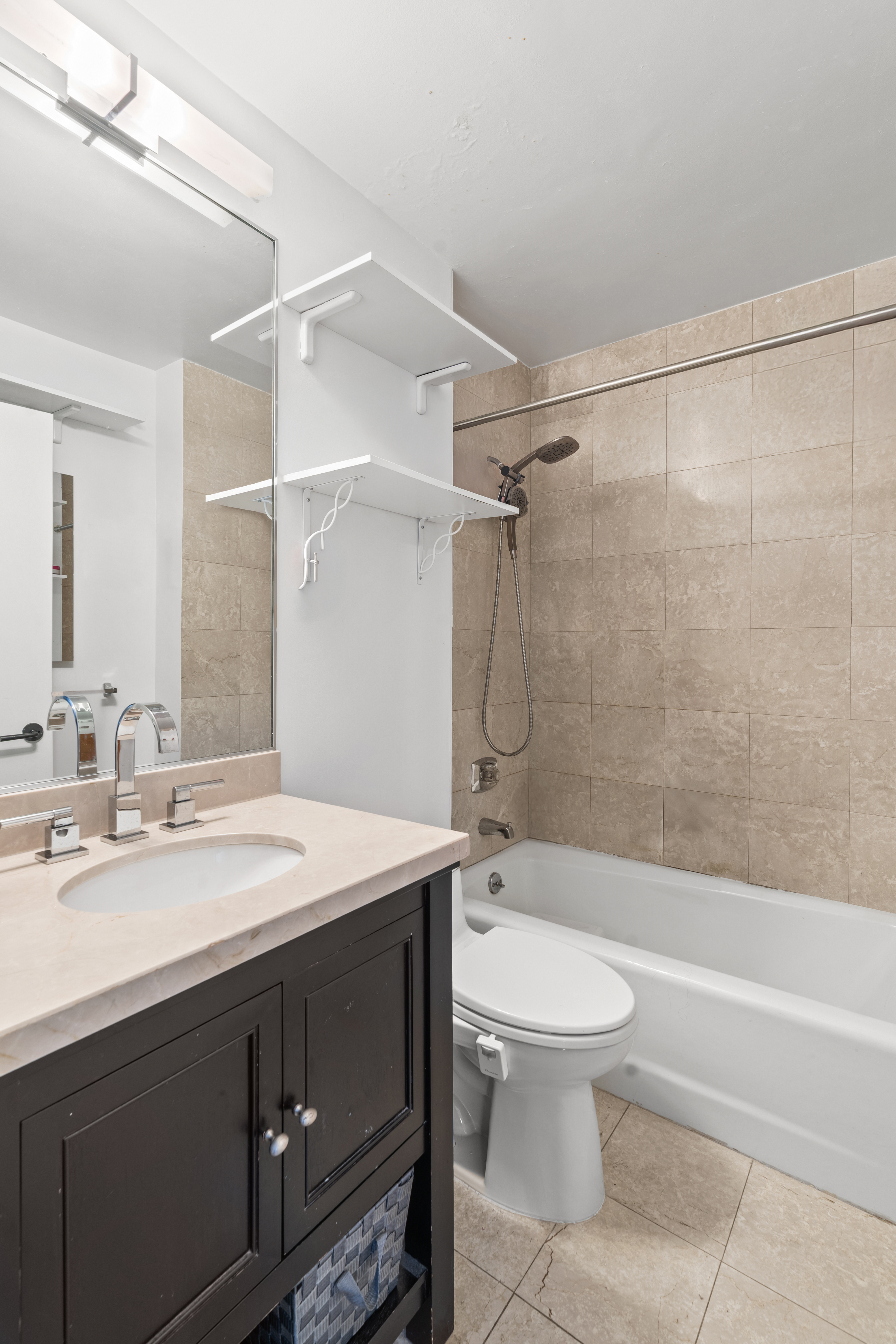 330 East 75th Street, Unit 4K Manhattan, NY 10021 - Photo 6 of 9 a bathroom with a sink a toilet and a bathtub
