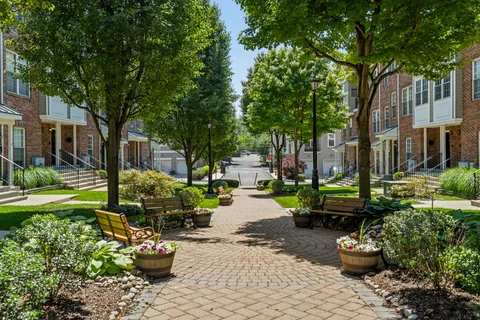 a view of a backyard with sitting area and garden