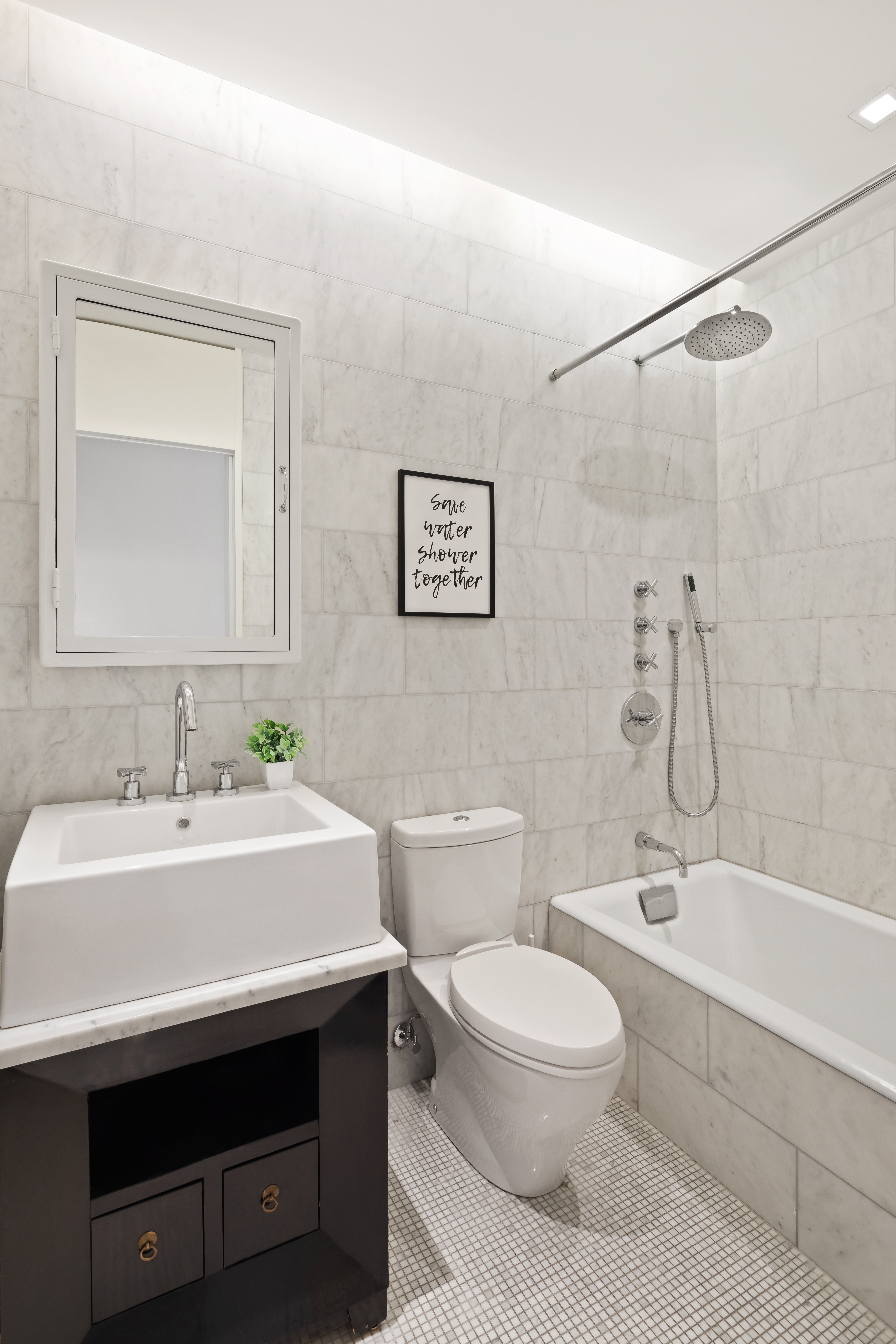 35 Spring Street Manhattan, NY 10012 - Photo 10 of 14 a bathroom with a sink a toilet and a bathtub