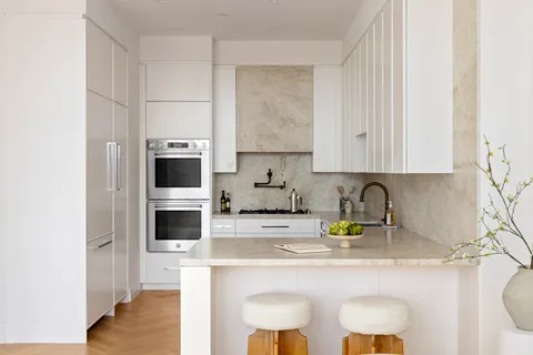 a kitchen with appliances a sink and cabinets