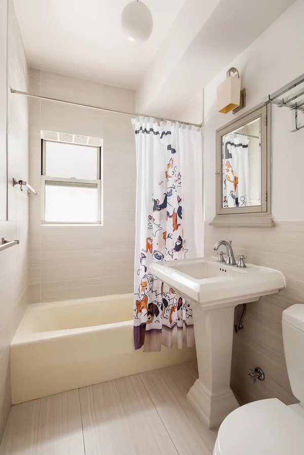 a bathroom with a sink mirror toilet and bathtub