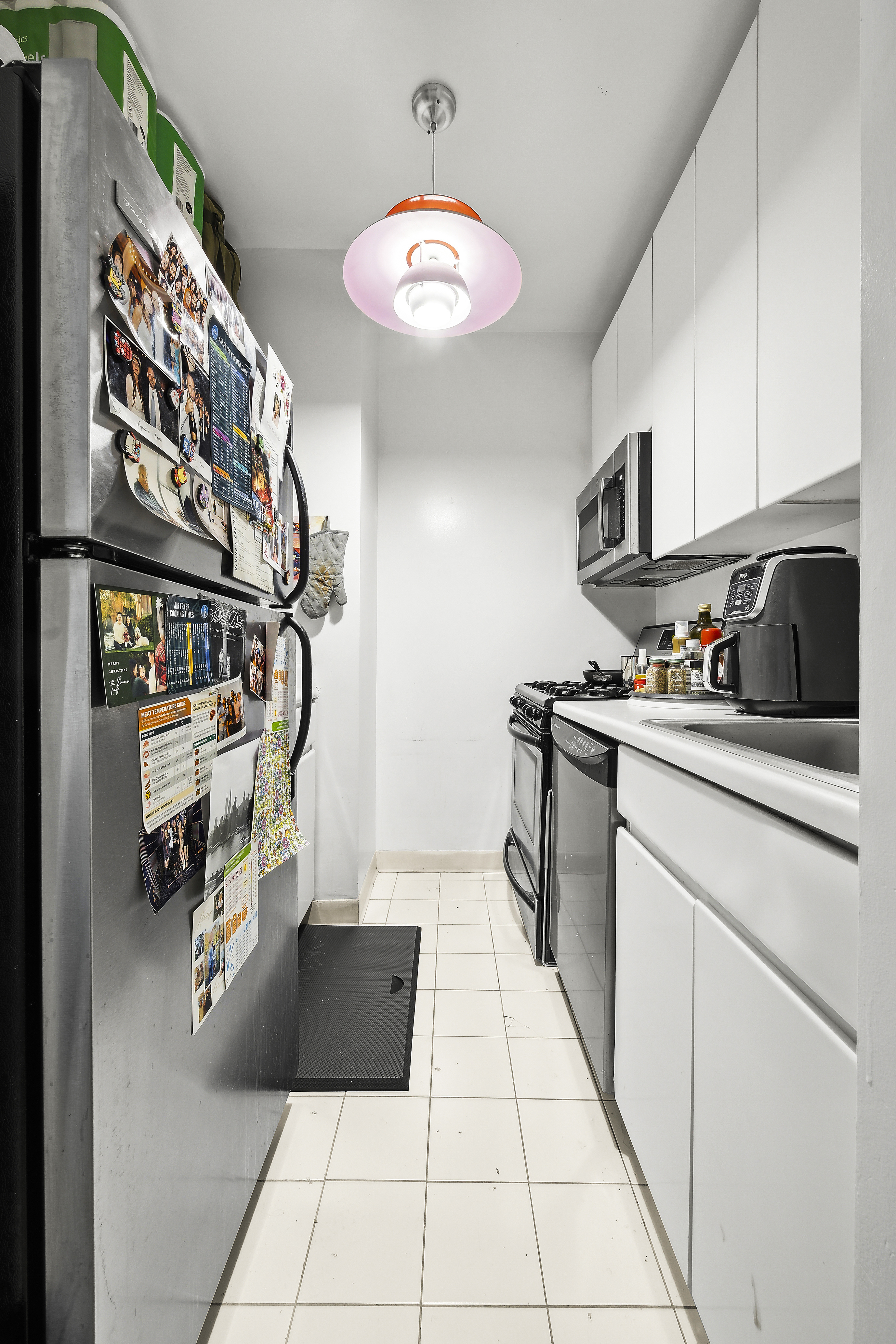 455 East 86th Street, Unit 5E Manhattan, NY 10028 - Photo 3 of 5 a kitchen with a cabinets and window