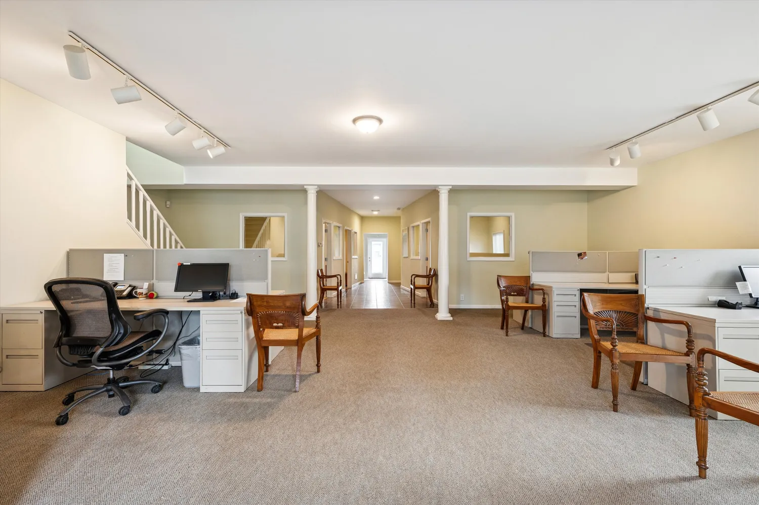 a view of a livingroom with furniture and a workspace