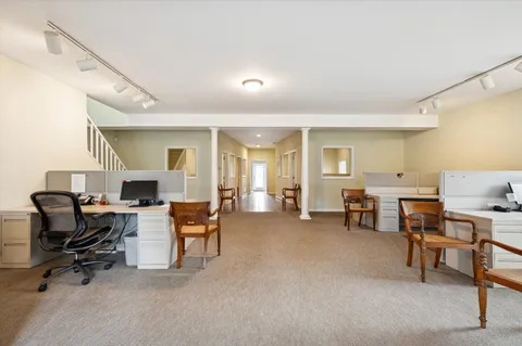 a view of a livingroom with furniture and a workspace