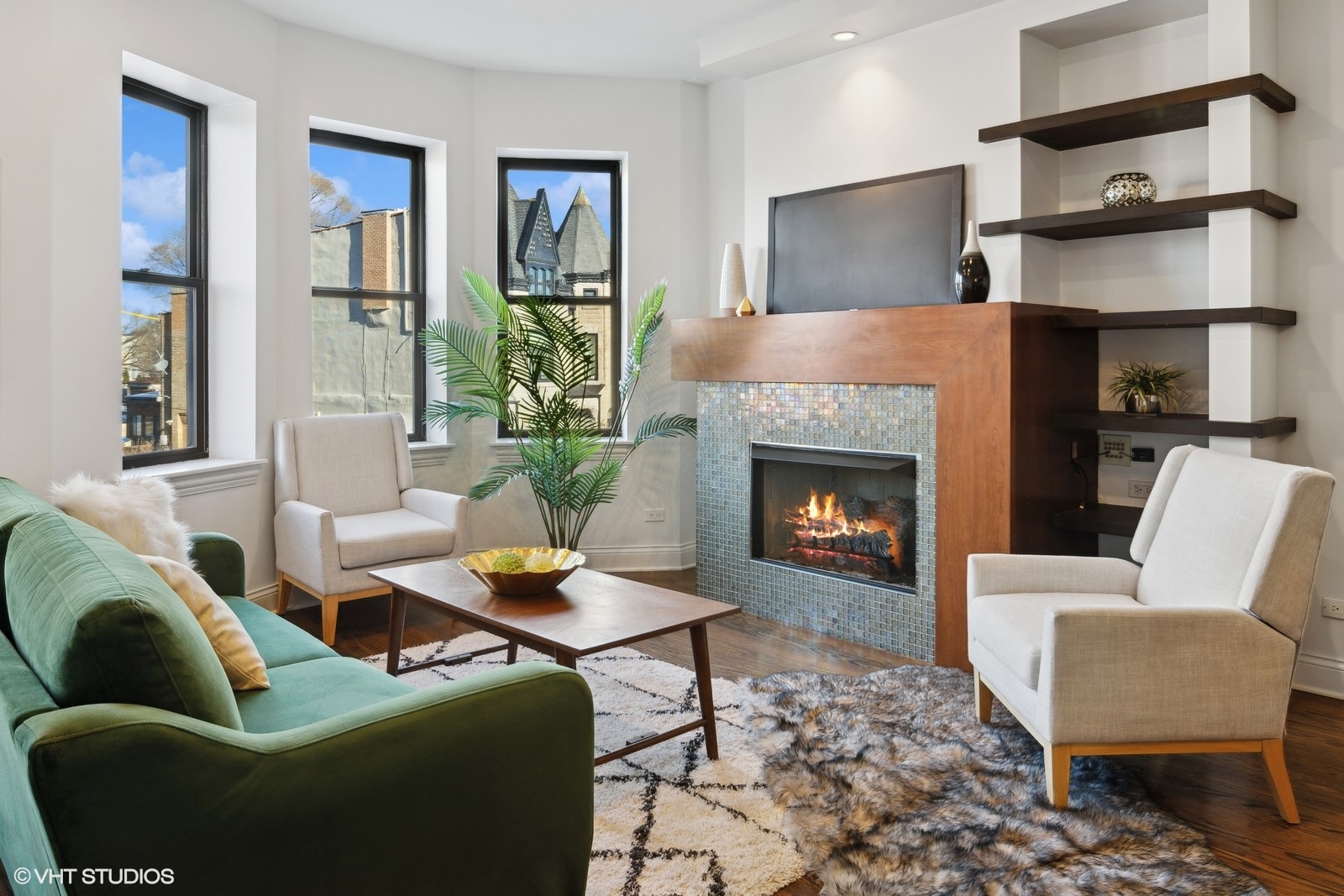 1227 East 46th Street, Unit 2E Chicago, IL 60653 - Photo 2 of 16 a living room with furniture and a fireplace