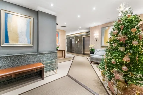 a lobby with furniture and a potted plant