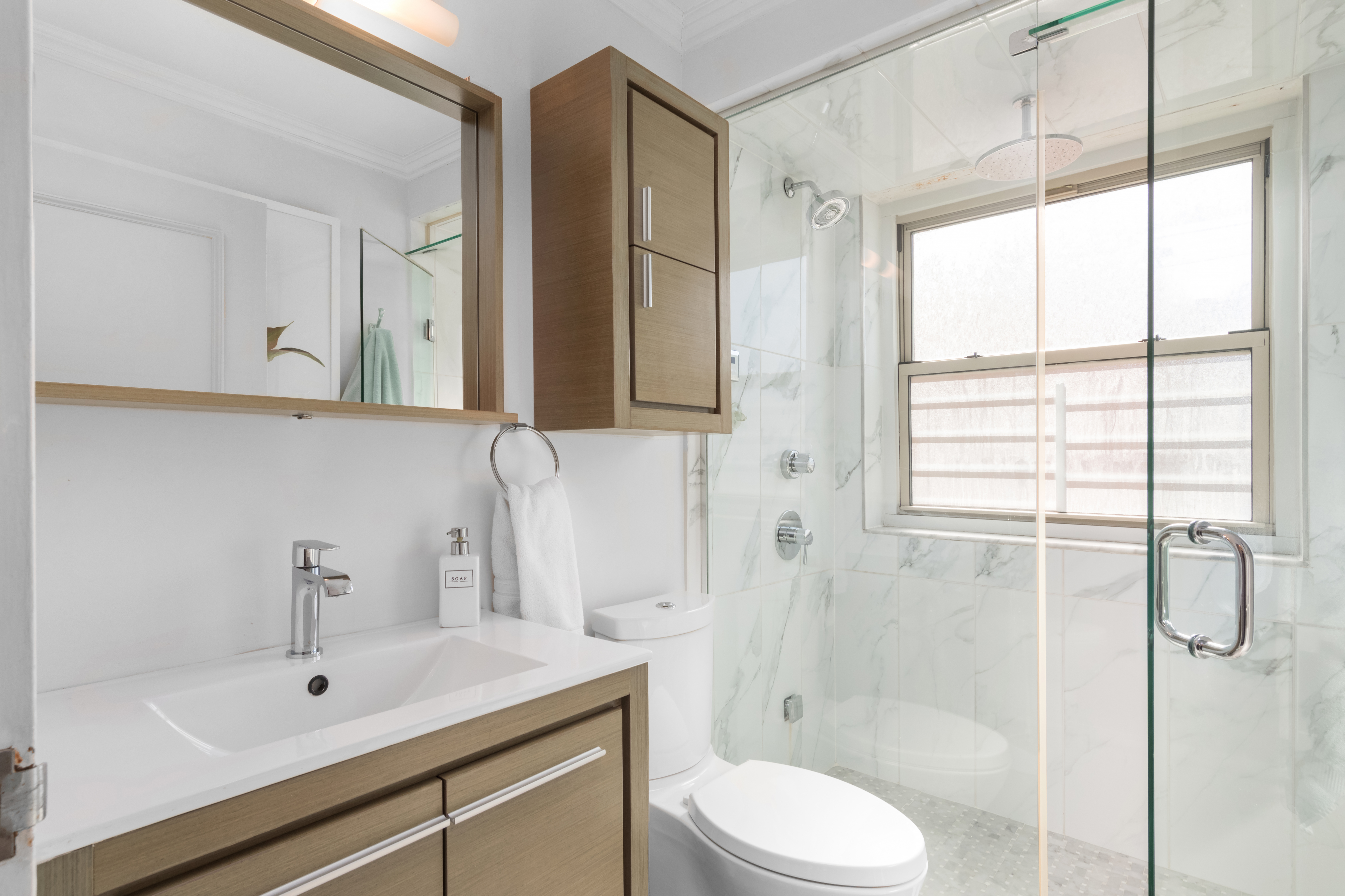 137 East 36th Street, Unit 21F Manhattan, NY 10016 - Photo 12 of 20 a bathroom with a sink toilet a mirror and shower