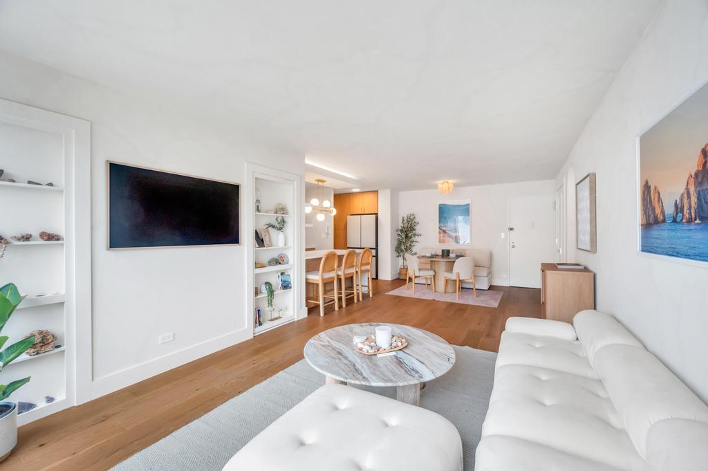 175 West 12th Street, Unit 5E Manhattan, NY 10011 - Photo 11 of 22 a living room with furniture and a flat screen tv