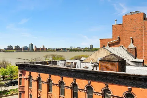 a view of swimming pool with outdoor seating and city view