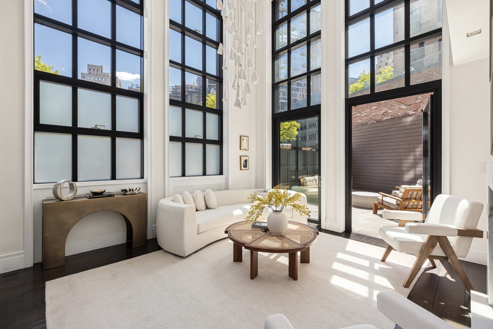 137 Franklin Street, Unit 1 Manhattan, NY 10013 - Photo 2 of 25 a living room with furniture and a large window