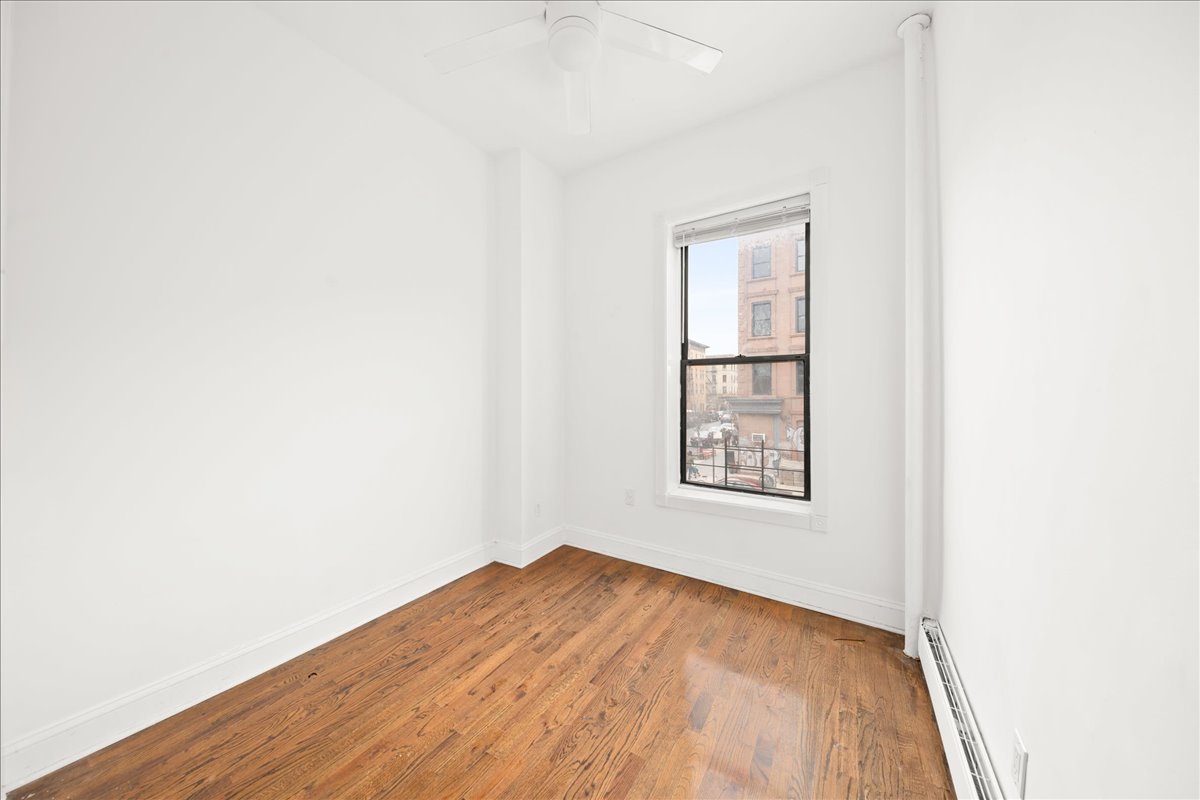 478 Halsey Street, Unit 1 Brooklyn, NY 11233 - Photo 8 of 10 a view of a big room with wooden floor and windows