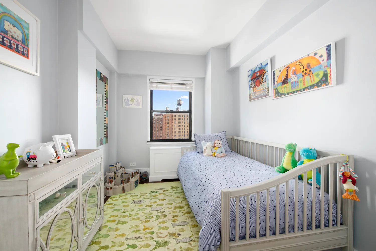 a bedroom with a bed a baby crib and a window