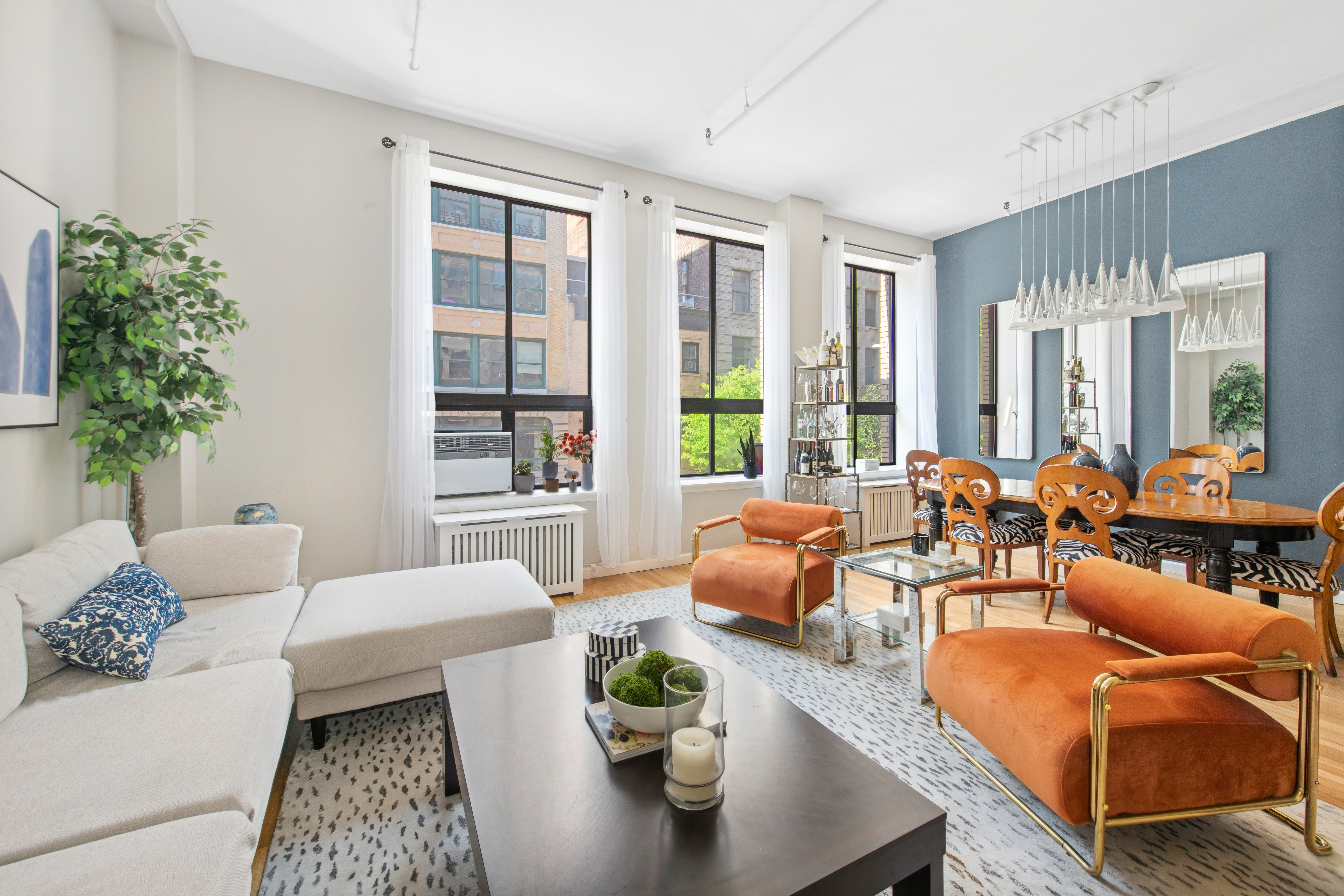 112 West 18th Street, Unit 2A Manhattan, NY 10011 - Photo 5 of 10 a living room with furniture and a large window