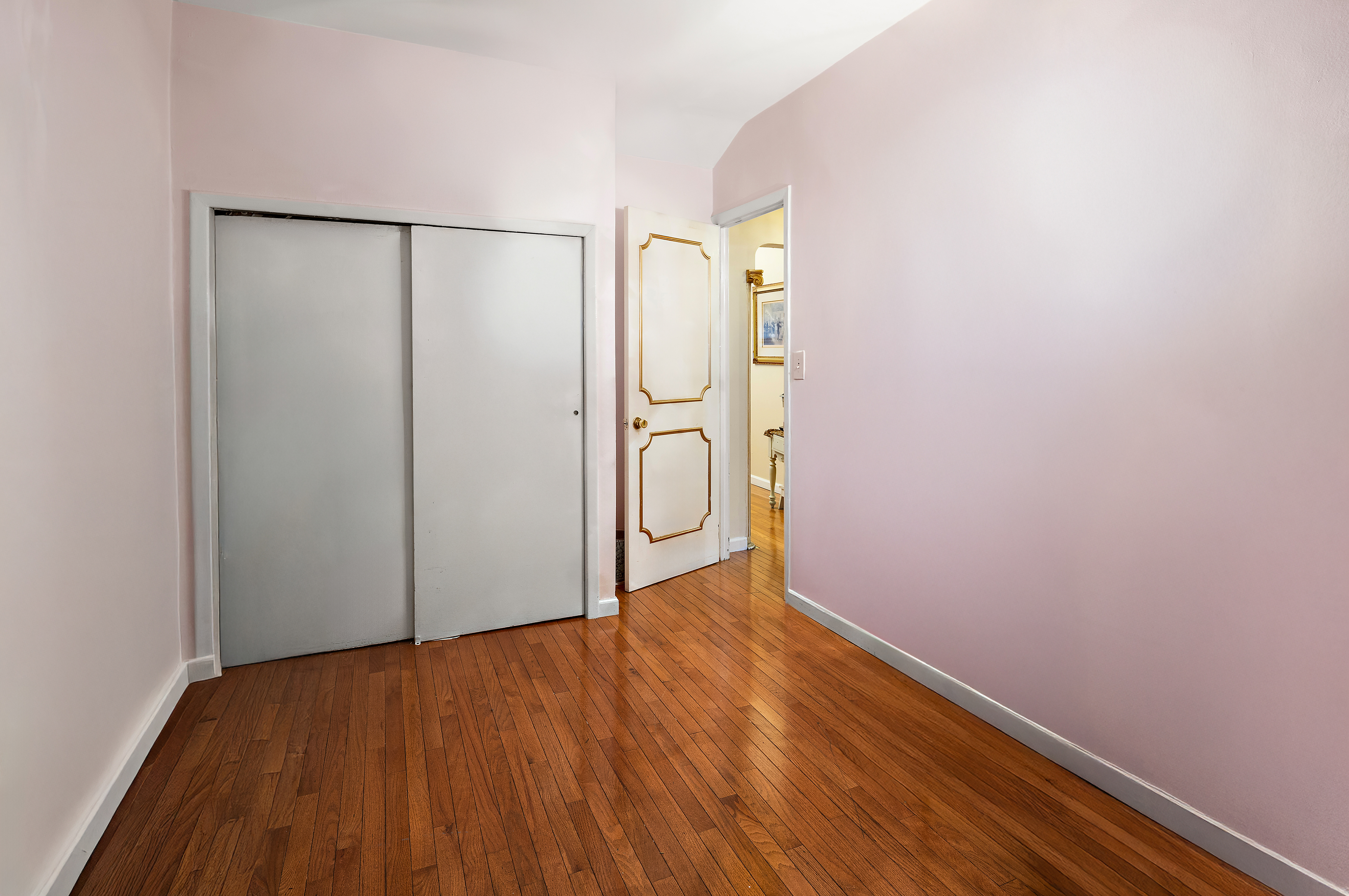 562 84th Street Brooklyn, NY 11209 - Photo 16 of 25 a view of an empty room with wooden floor and a window