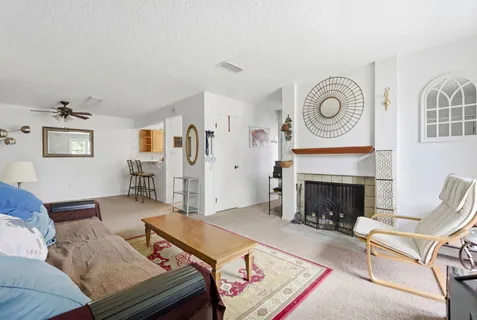 a living room with furniture and next to a window