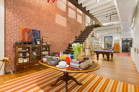 a lobby with furniture and stairs