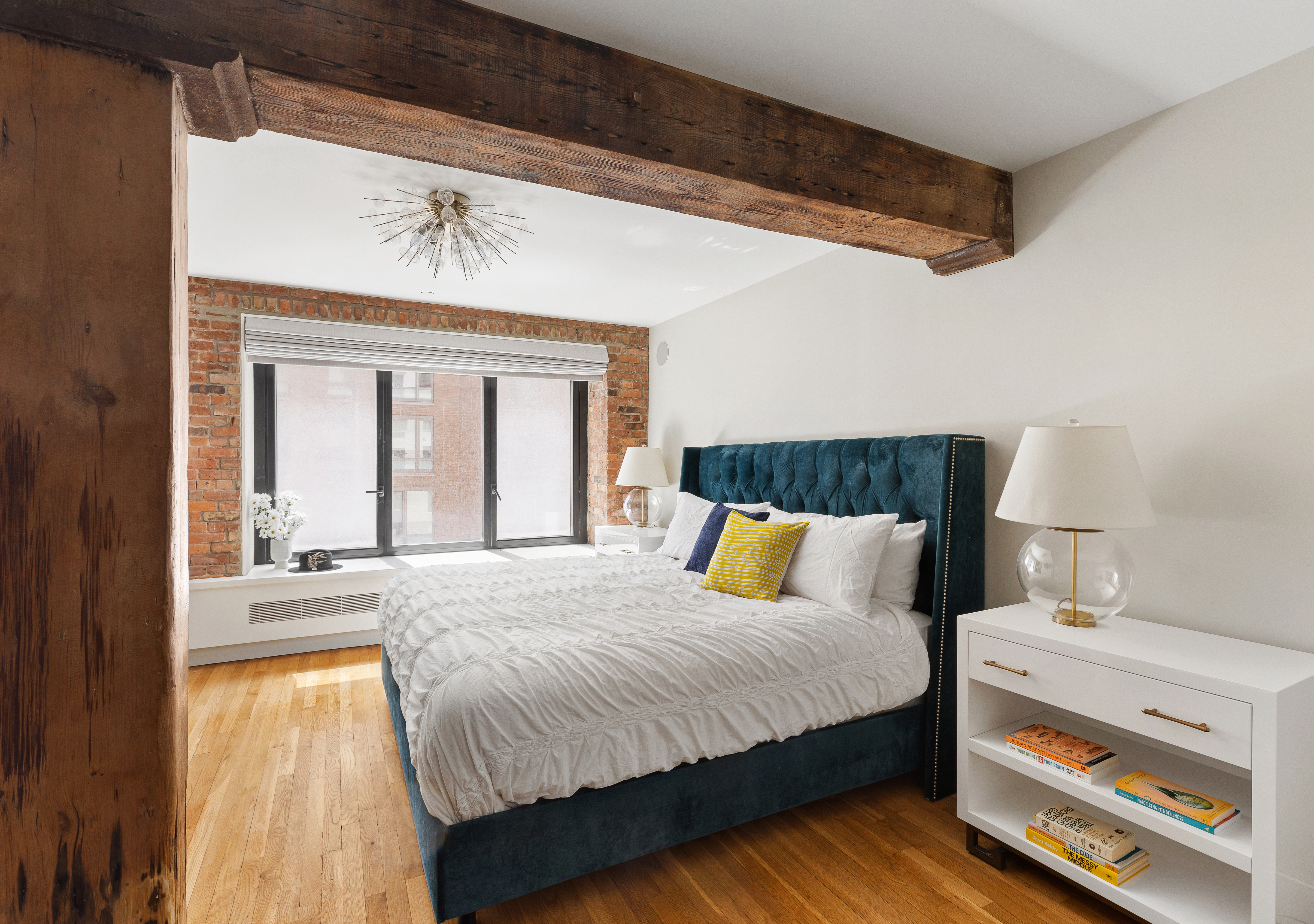 466 Washington Street, Unit 3W Manhattan, NY 10013 - Photo 7 of 14 a bedroom with a bed and a potted plant on the dresser