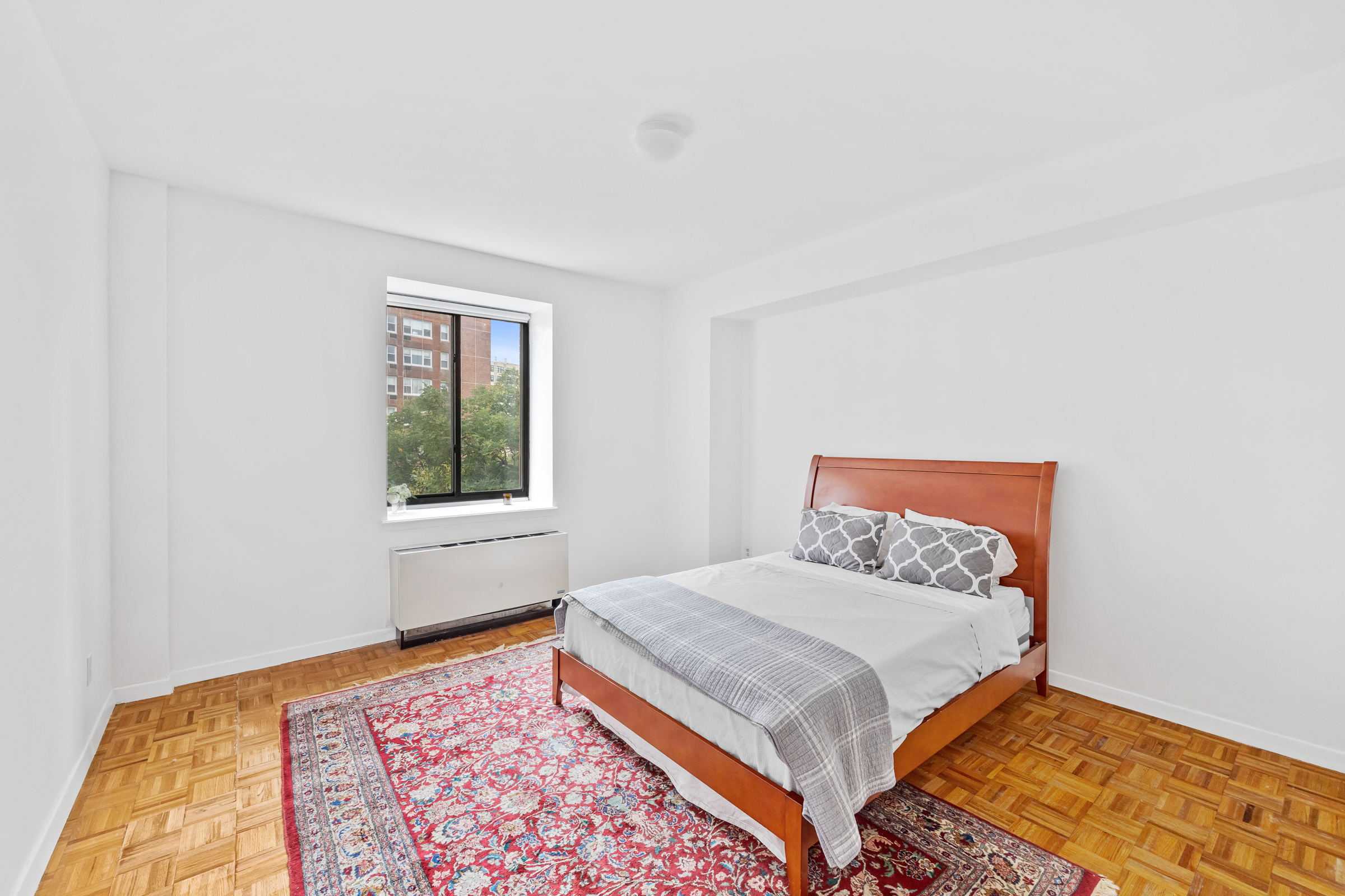 196 6th Avenue, Unit 5A Manhattan, NY 10013 - Photo 9 of 12 a bed sitting in a bedroom next to a window