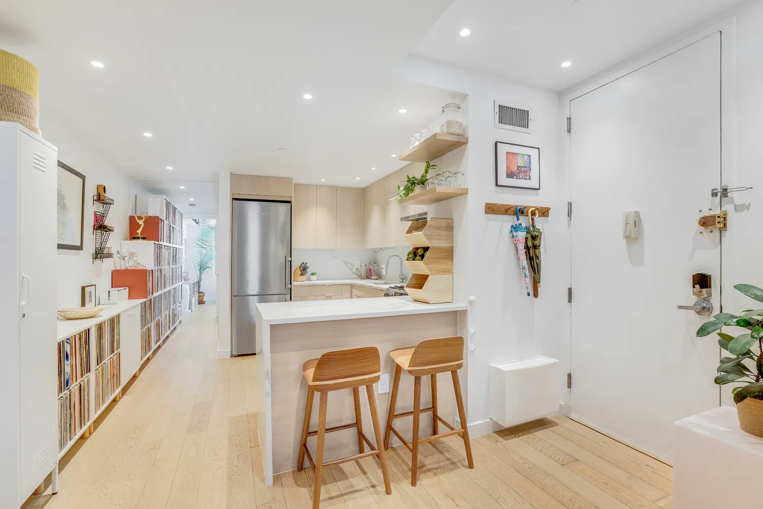 a kitchen with stainless steel appliances kitchen island granite countertop a refrigerator and a sink