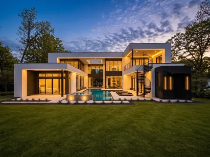 a view of a house with a big yard and large trees