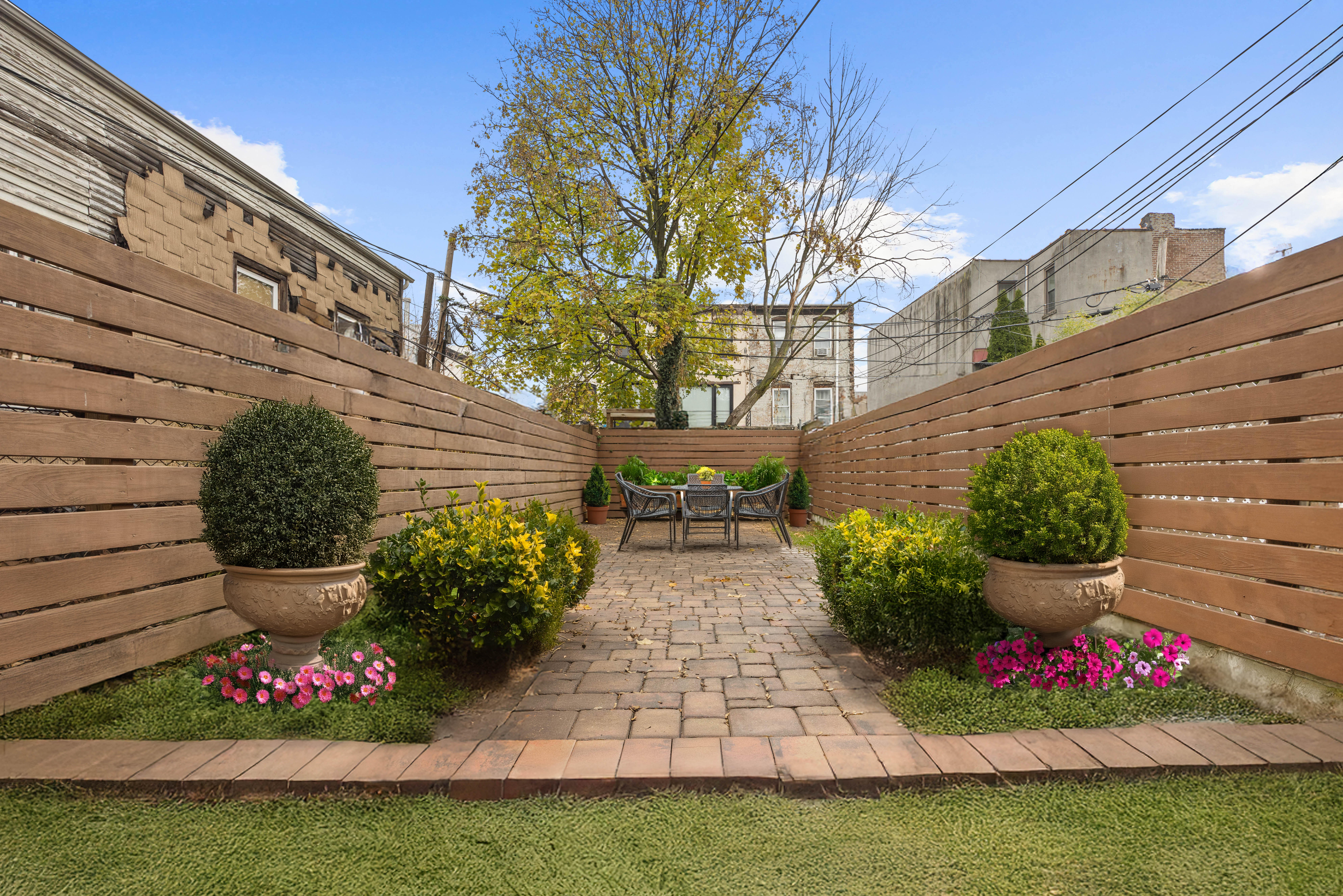 11A Dewey Place Brooklyn, NY 11233 - Photo 9 of 12 a view of a house with a yard and garden