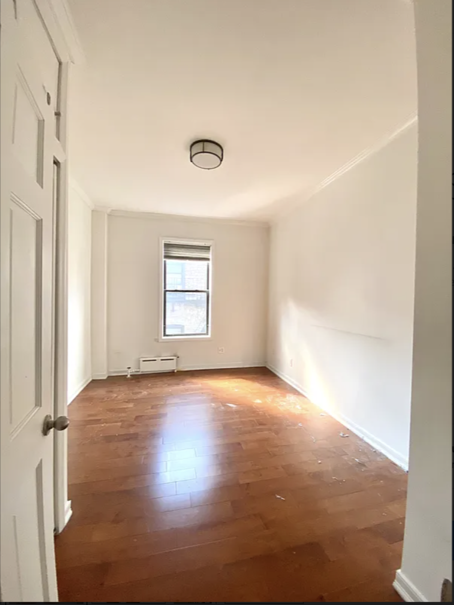567 6th Street, Unit 10 Brooklyn, NY 11215 - Photo 7 of 14 a view of an empty room with wooden floor and a window