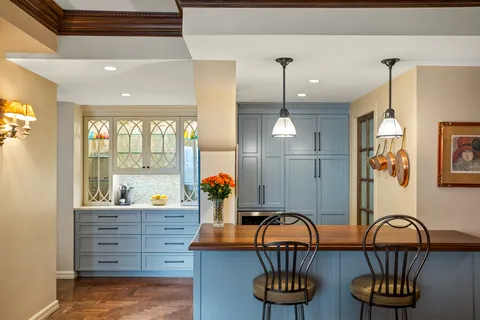 a kitchen with stainless steel appliances kitchen island granite countertop a stove a sink and a dining table with wooden floor