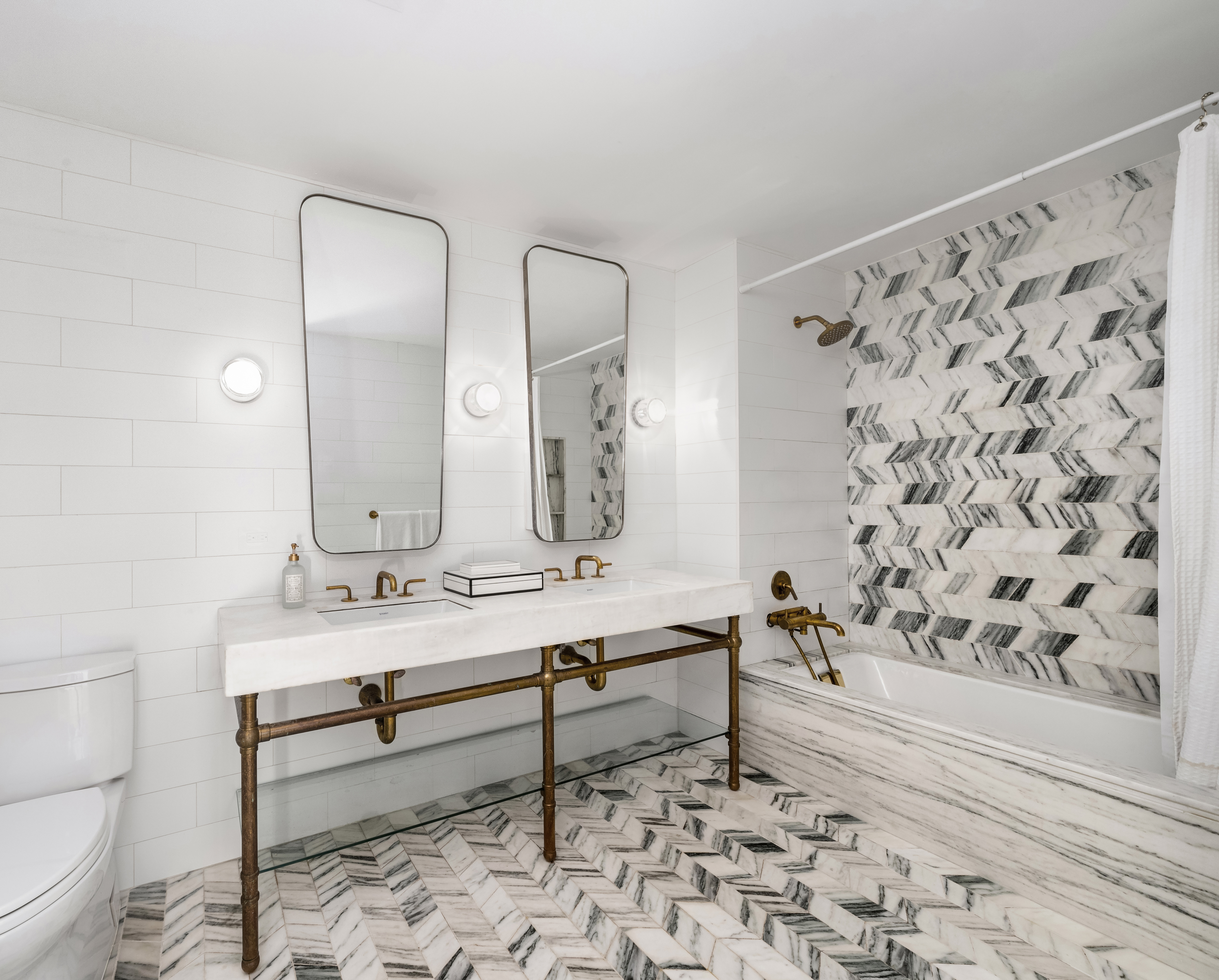 50 Clinton Street, Unit 4A Manhattan, NY 10002 - Photo 5 of 12 a bathroom with a sink toilet and shower