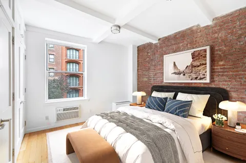 a bedroom with bed and a window