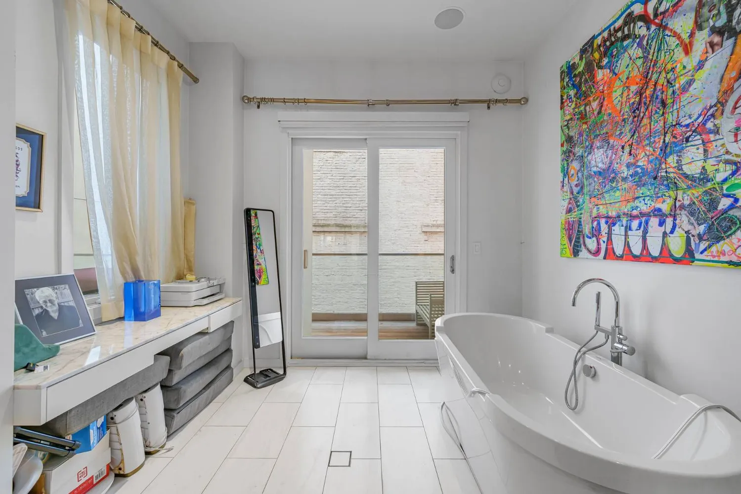 a spacious bathroom with a double vanity sink and a tub