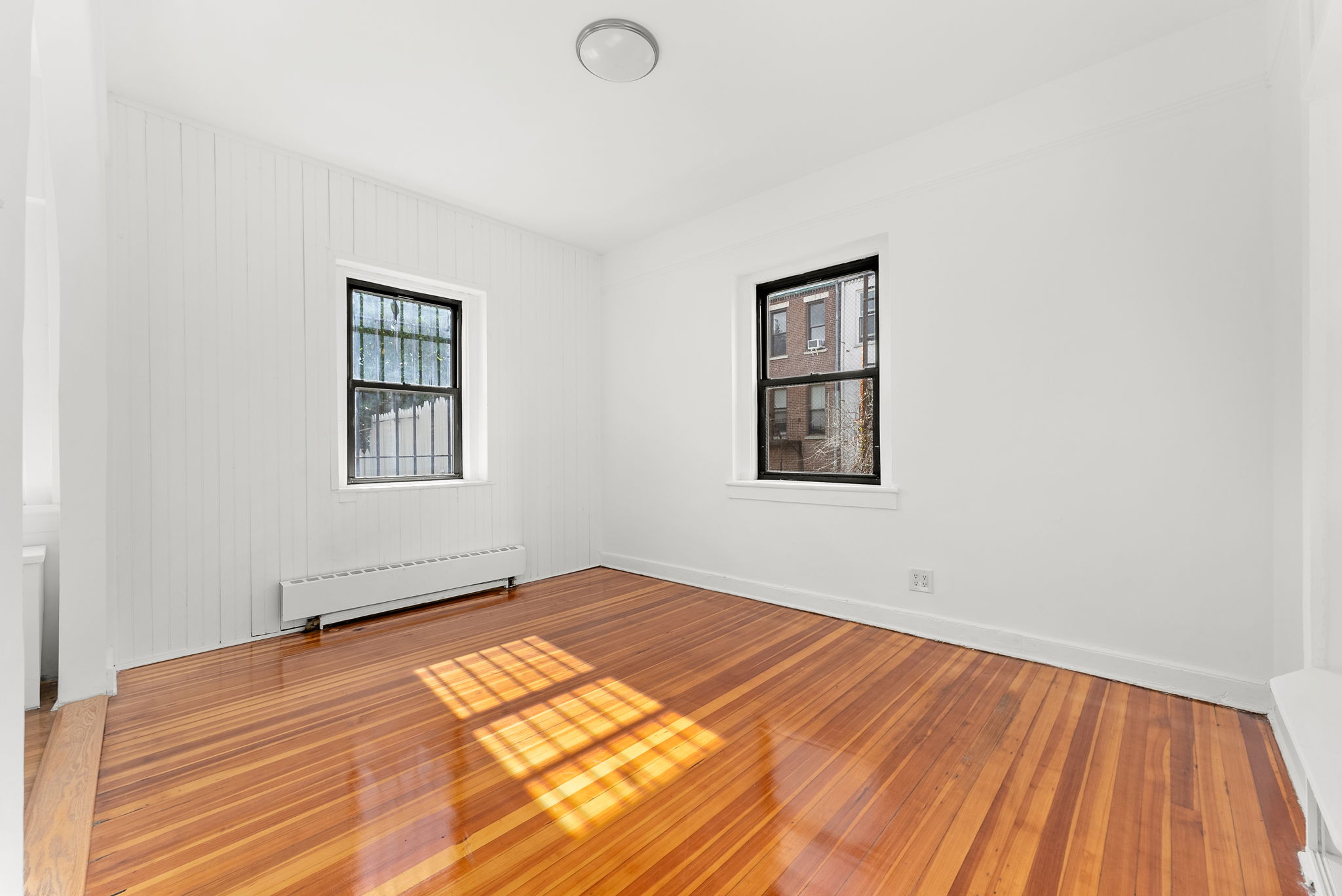 710 Carroll Street Brooklyn, NY 11215 - Photo 6 of 10 a view of empty room with wooden floor and fan
