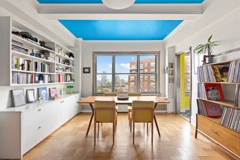 a dining room with furniture and a book shelf