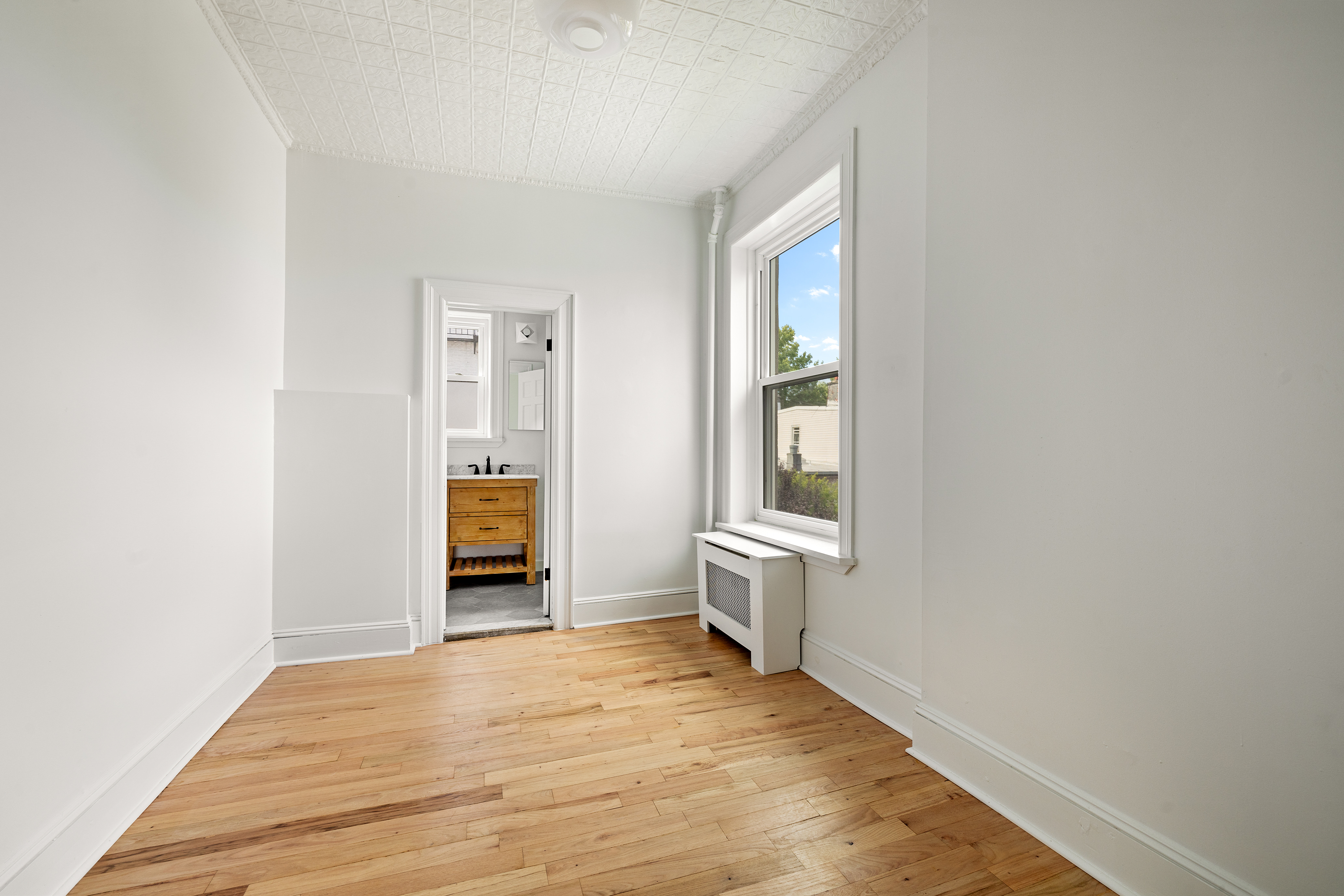 456 Prospect Avenue, Unit 3R Brooklyn, NY 11215 - Photo 12 of 16 an empty room with wooden floor and windows