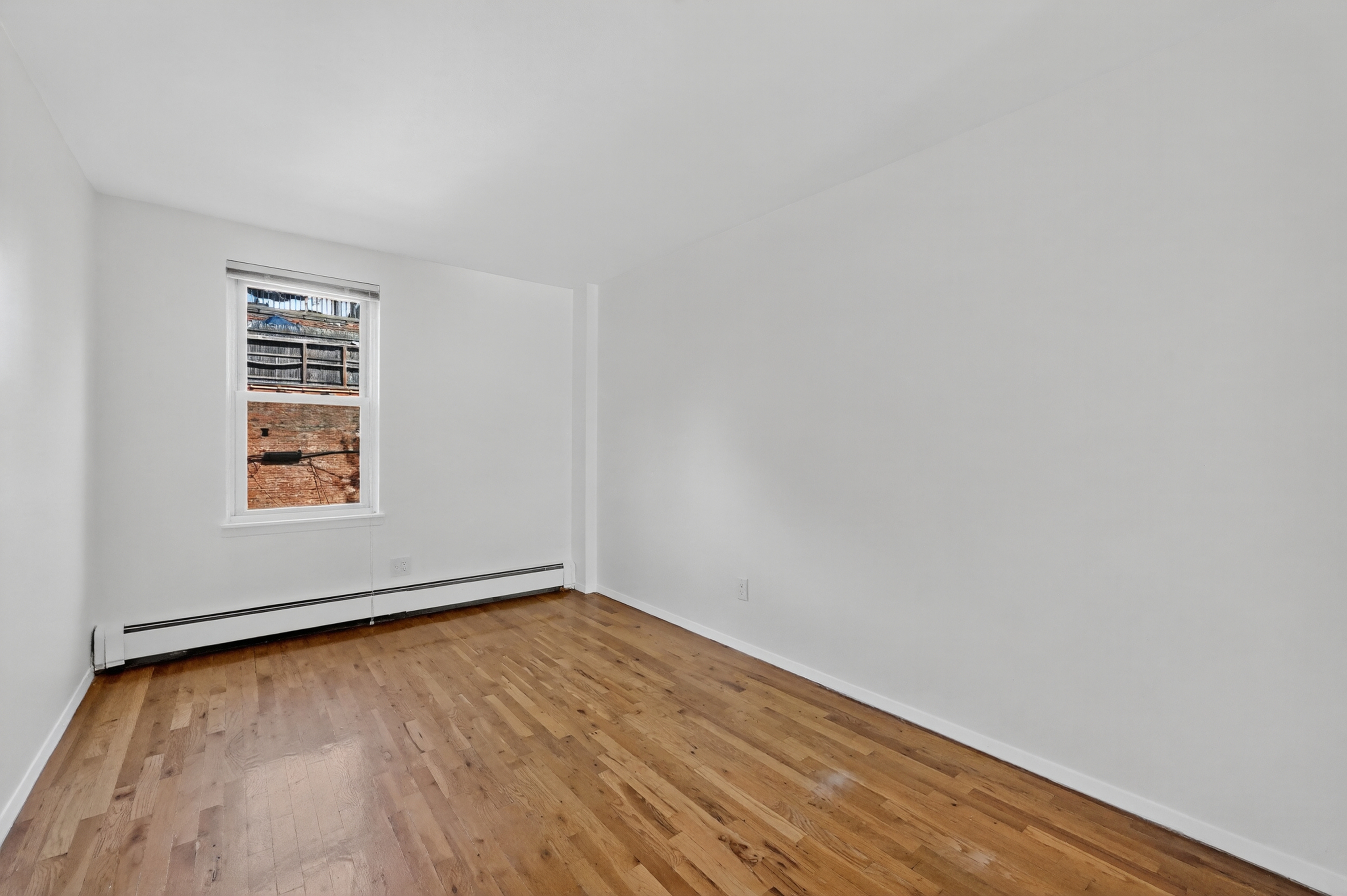 81 President Street, Unit 51-A Brooklyn, NY 11231 - Photo 24 of 27 a view of an empty room with wooden floor and a window