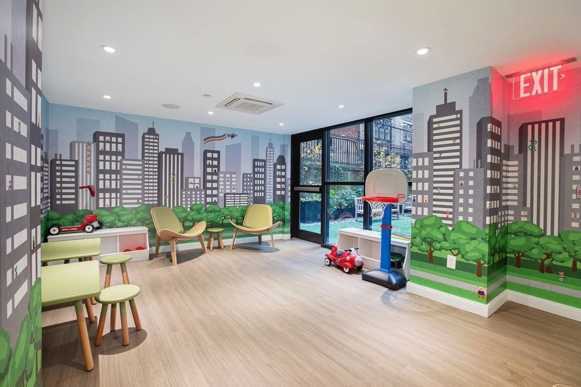 12 East 88th Street, Unit 8A Manhattan, NY 10128 - Photo 14 of 19 a playing room with furniture and a floor to ceiling window