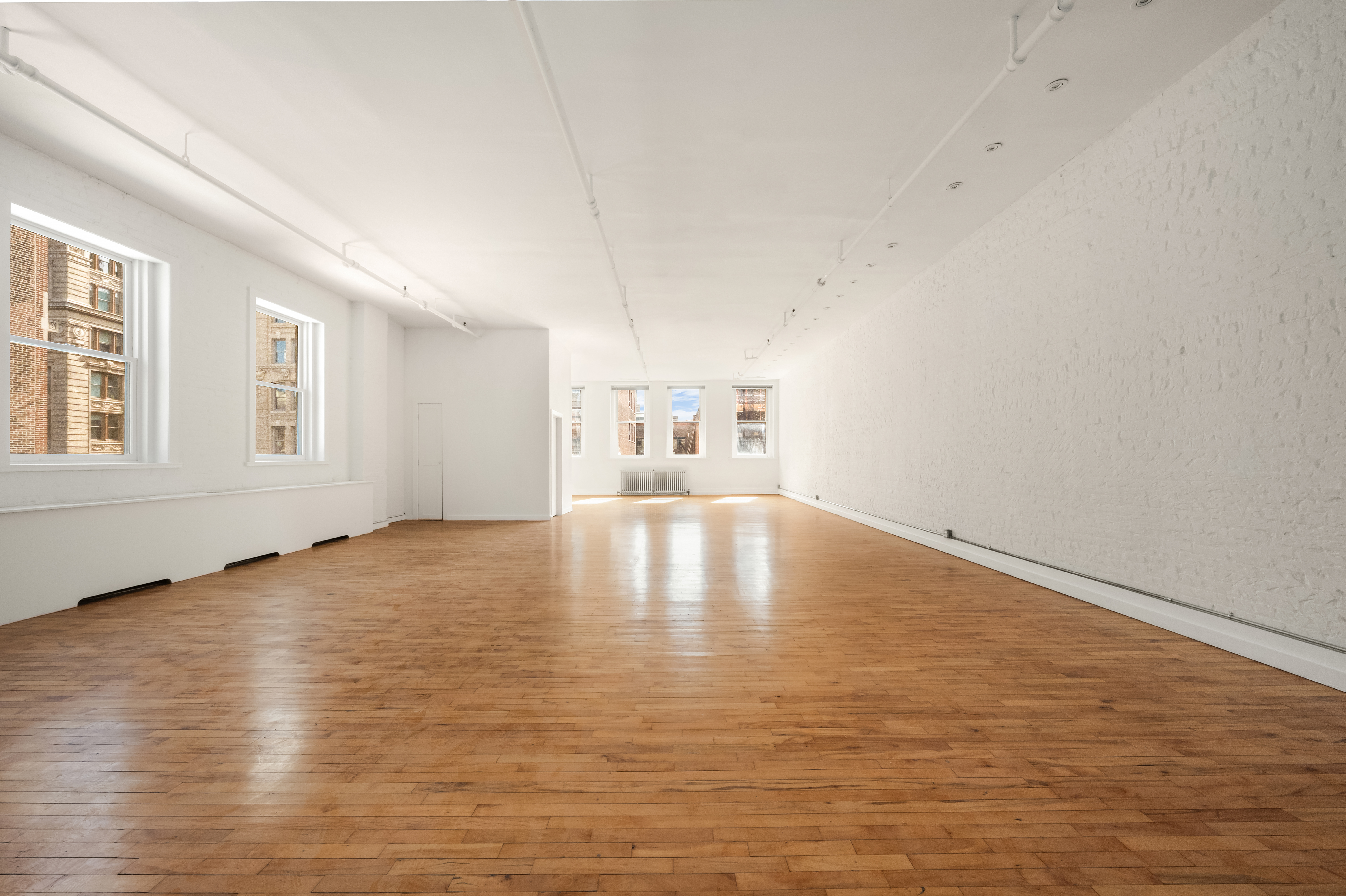 519 Broadway, Unit PHC Manhattan, NY 10012 - Photo 3 of 16 a view of empty room with wooden floor